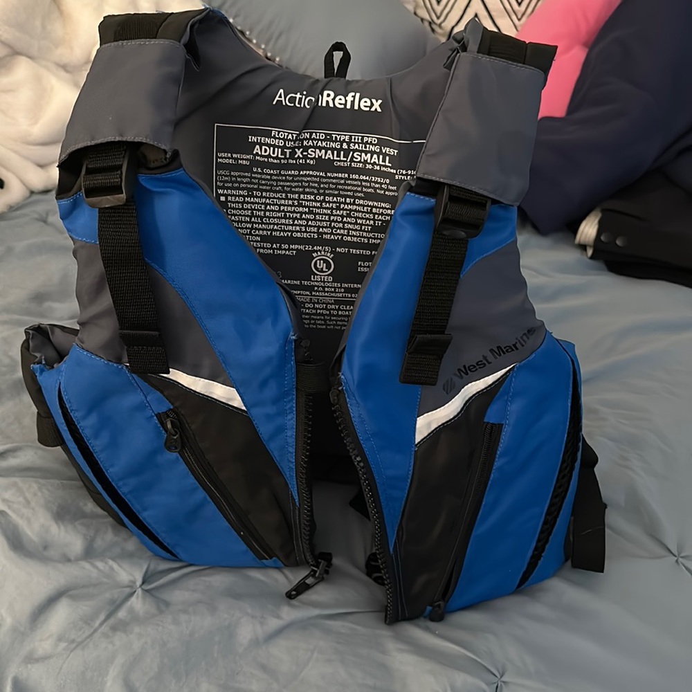 West Marine life jacket, adult XS, never used, and in ok condition.